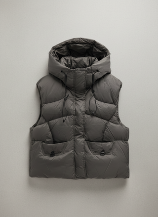 Gray puffer vest with a hood on a light gray background