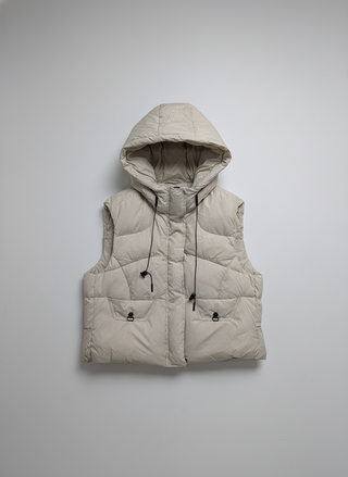 Beige puffer vest with a hood on a light gray background