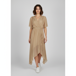 A woman with short brown hair stands facing forward, wearing a light Beige  V-neck wrap midi dress with short sleeves, a tie waist, and an asymmetrical hem, paired with white sneakers.